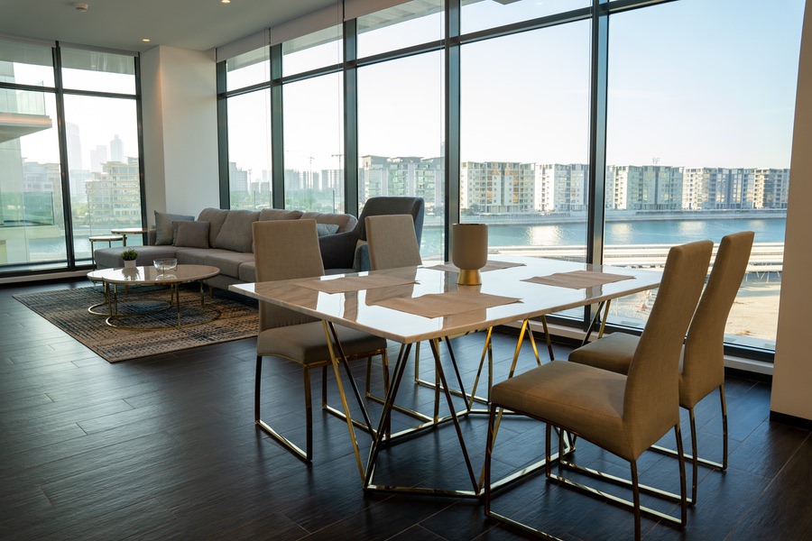 Luxury penthouse dining area with a waterfront view and premium finishes by Almoayyed Contracting Group.