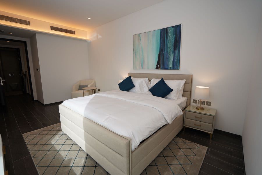 Bespoke bedroom interior featuring elegant lighting and modern decor by Almoayyed Contracting Group.