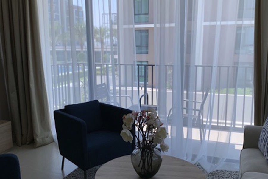 Contemporary apartment living area featuring designer furniture and floor-to-ceiling windows by Almoayyed Contracting Group.