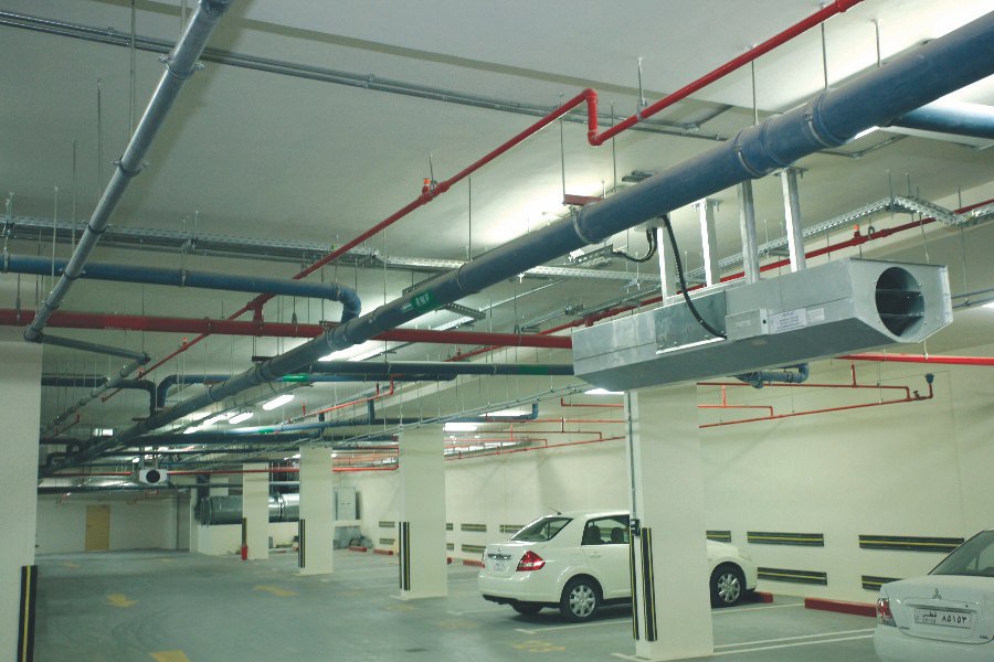 Underground parking facility featuring professional electrical and fire safety ducting by Almoayyed Contracting Group.
