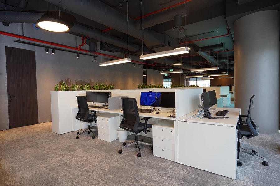 Professional open-plan office workspace with high-end finishing by Almoayyed Contracting Group.