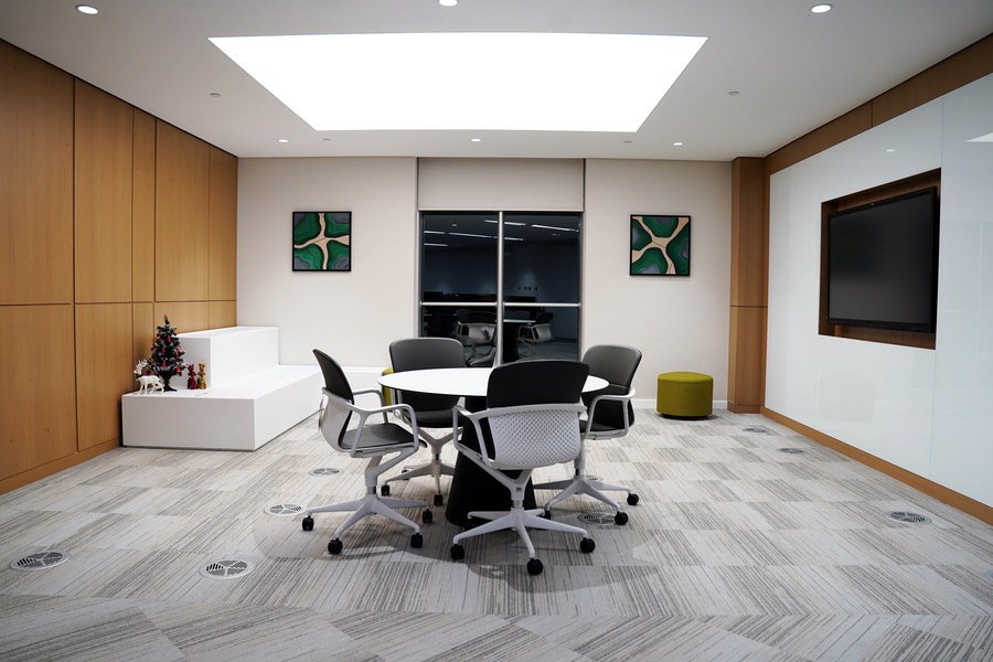 Sleek executive conference room featuring modern lighting and furniture by Almoayyed Contracting Group.