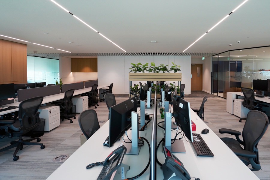 Modern open-plan office interior fit-out with workstations by Almoayyed Contracting Group.