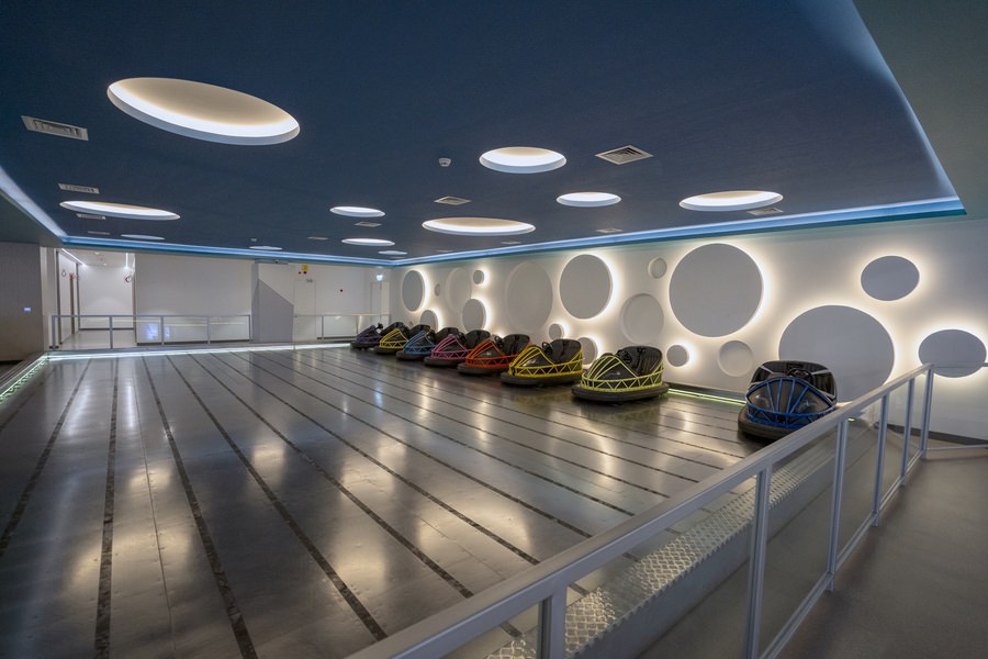 Contemporary commercial lobby featuring reflective flooring and futuristic lighting by Almoayyed Contracting Group.