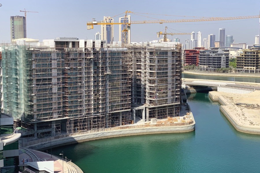 Aerial view of Almoayyed Contracting Group waterfront high-rise construction project in Bahrain.