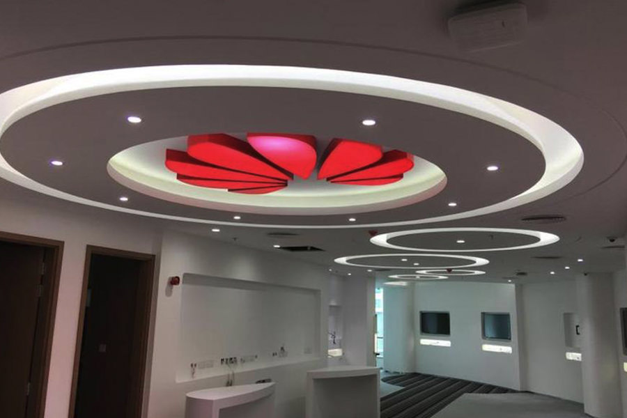Circular recessed ceiling with red LED lighting for a modern office interior by Almoayyed Contracting Group.