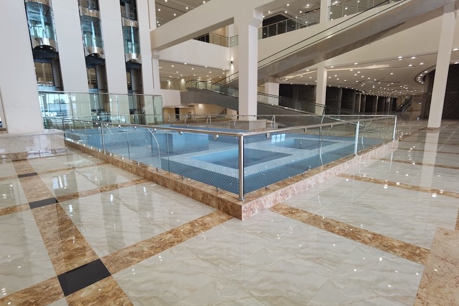 Interior design and marble flooring for a commercial building lobby by Almoayyed Contracting Group.