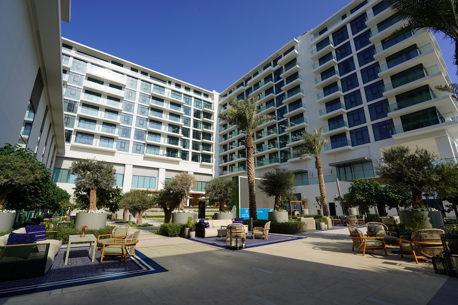 Exterior facade of a large-scale commercial complex featuring architectural landscaping by Almoayyed Contracting Group.