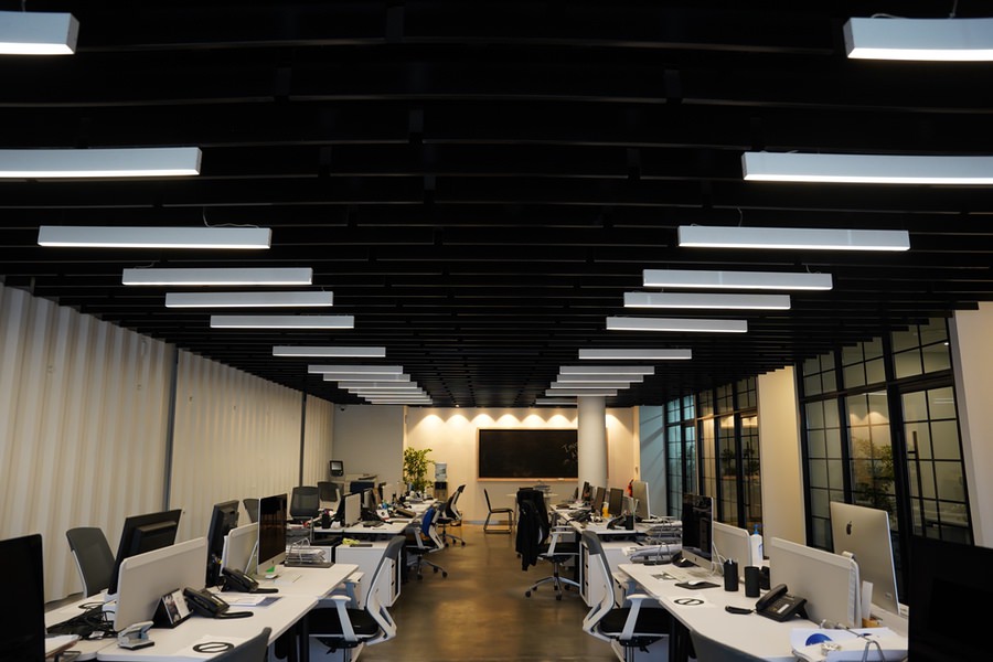 Large scale commercial office space with industrial ceiling design by Almoayyed Contracting Group.