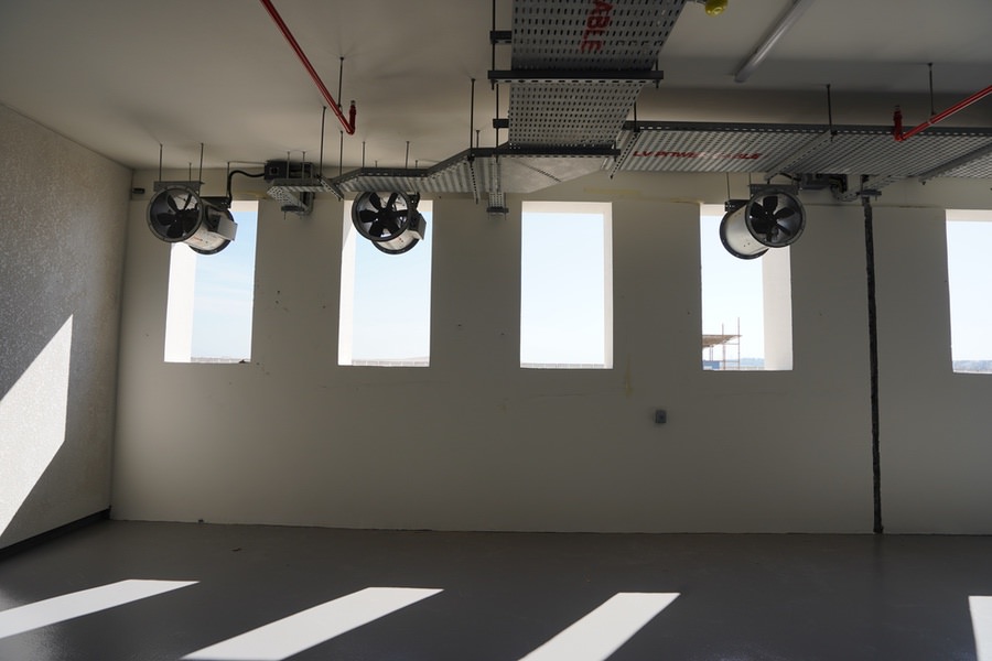 Interior view of an industrial facility with professional MEP and HVAC ducting by Almoayyed Contracting Group.