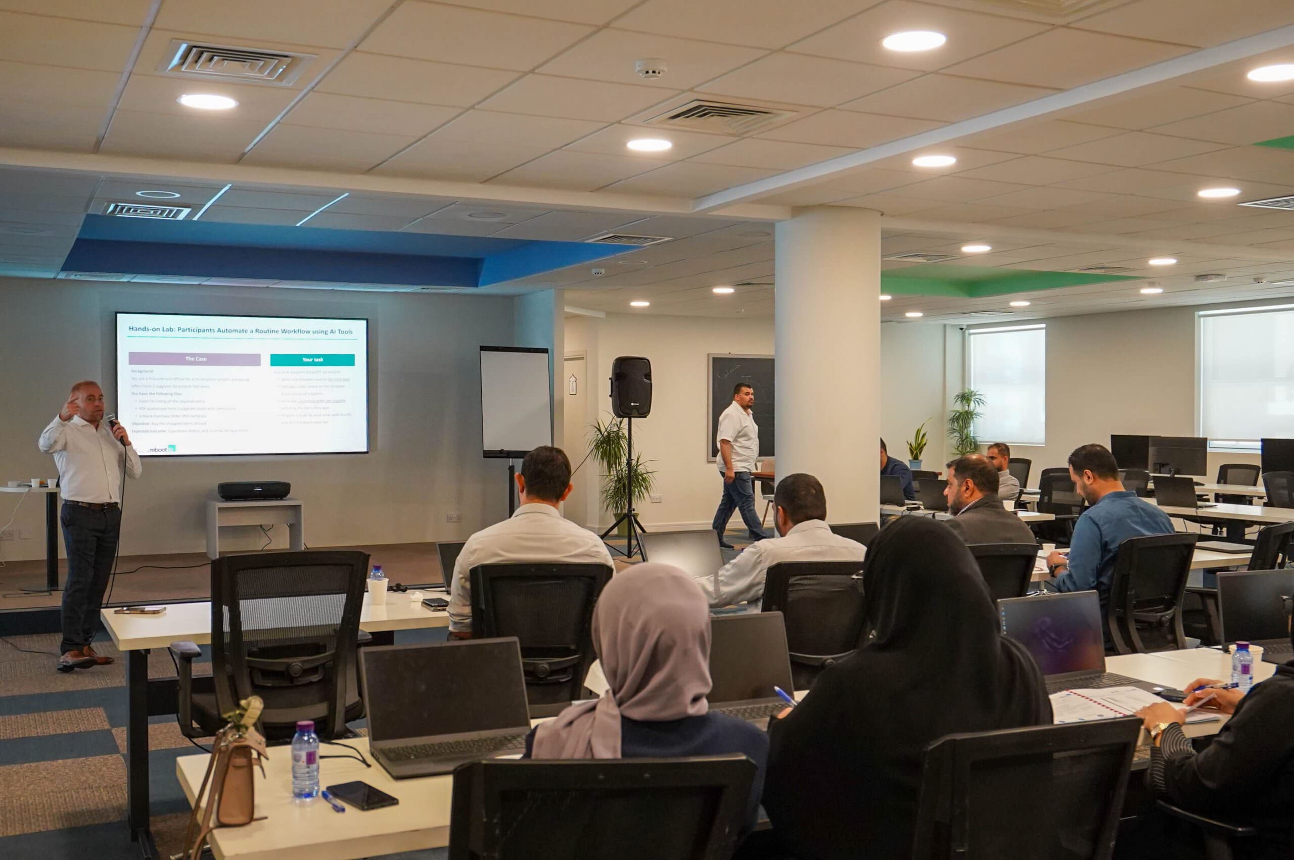 Almoayyed Contracting Group employees attending a corporate training seminar in a conference room.